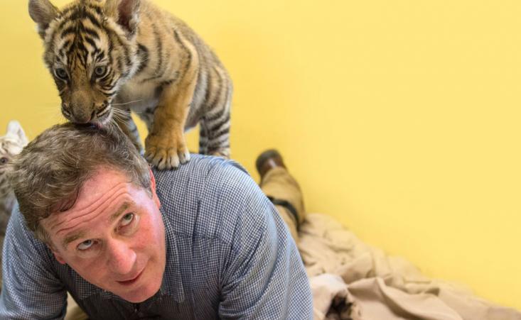 Joel Sartore with baby tiger – Photo Ark Project